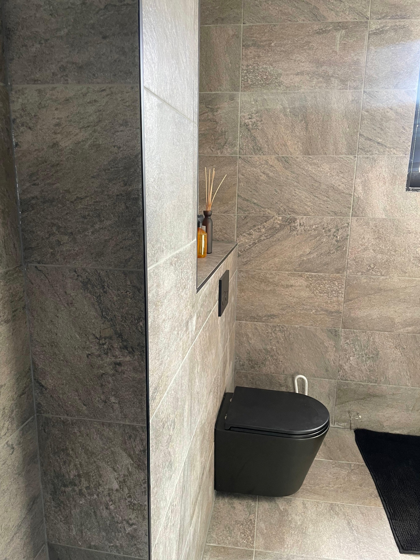 Zwevend zwart toilet met nis